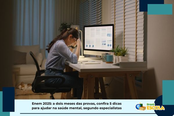 Enem 2025 Estudante com cabeça baixa em frente a mesa de estudos